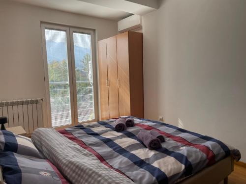 a bedroom with a bed with two stuffed animals on it at Big Apartment with private parking - EXTRA VIEW in Skopje