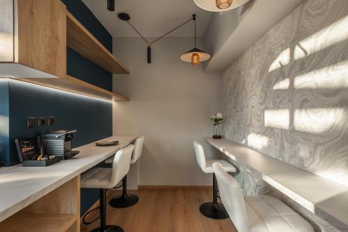 an office with a long desk and white chairs at Ethereal Athεns in Athens