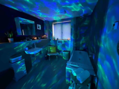 a blue room with a room with a fish tank at River Vista Retreat - Luxury duplex Apt - Views - Parking - Cycle storage - Spa access option in Backbarrow