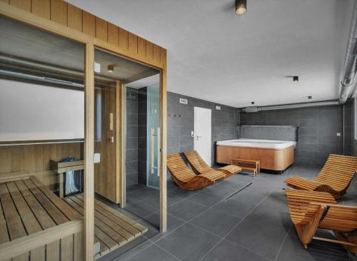 a room with a bed and some chairs and a room with a bed at Loft Rezidence Kotel in Rokytnice nad Jizerou