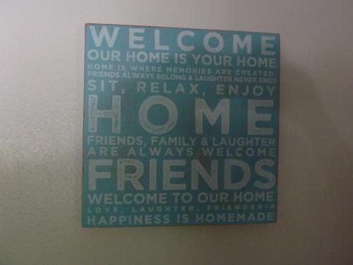 a sign on a wall with the words welcome to our home at Thorold Country House in Thames