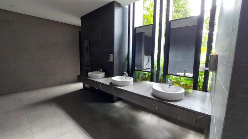 a bathroom with two sinks and two windows at Anggun Presidential Suites in Kuala Lumpur