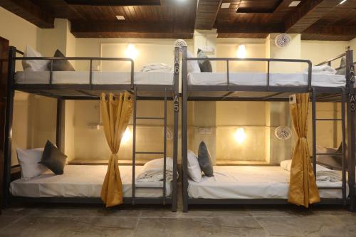 a couple of bunk beds in a room at Perfect Stayz Aiims - Hotel Near Aiims Rishikesh in Rishīkesh