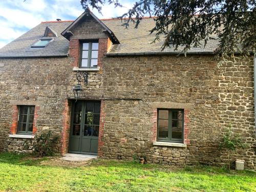 une vieille maison en briques avec une porte verte dans l'établissement MANOIR DE CLERMONT, à Saint-Malo