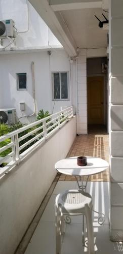 a white table and two chairs on a balcony at Innsite Room Rentals in Manila