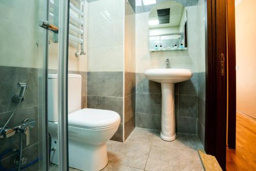 a bathroom with a toilet and a sink at Просторная квартира Баку in Baku