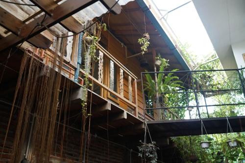 a building with a balcony with plants on it at Happy House BnB Bromo backpacker in Probolinggo