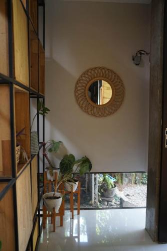 a room with a mirror and a table and chairs at Happy House BnB Bromo backpacker in Probolinggo