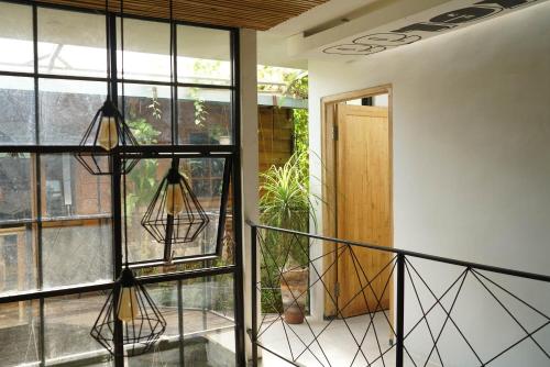 a room with a balcony with glass windows and a door at Happy House BnB Bromo backpacker in Probolinggo
