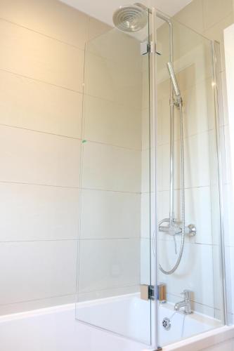 a shower with a glass door in a bathroom at Chaloners House, Free Parking, Large garden, Close to York Races & City Centre in York