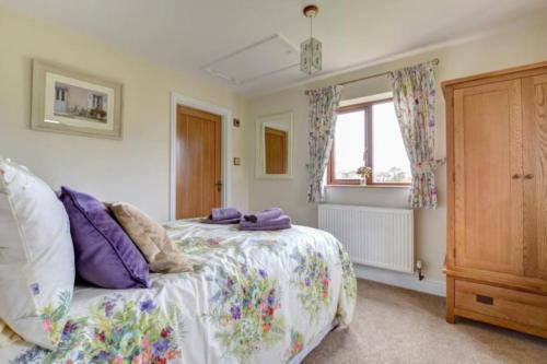 a bedroom with a bed and a window at Sunset View a quiet and romantic rural retreat for 2 adults just outside ingleton in Ingleton 