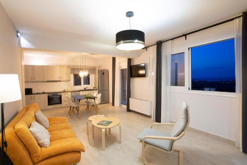 a living room with a couch and a table at Sea n' Smile in Apolpaina
