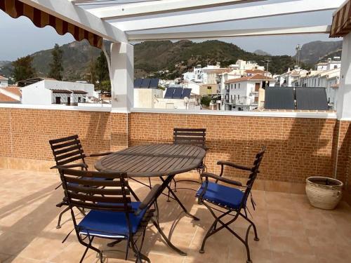 a table and chairs sitting on a patio at El ático de la Cañada in Frigiliana