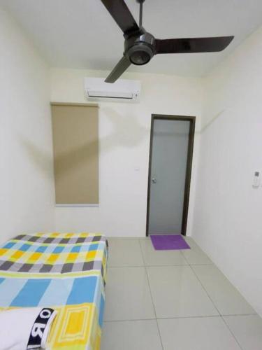 a room with a bed and a ceiling fan at Double Storey Sweet Home 12pax @ Puncak Alam in Kuala Selangor