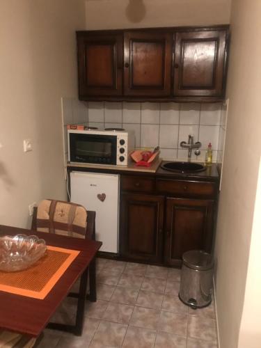 a small kitchen with a table and a microwave at Marija in Zlatibor