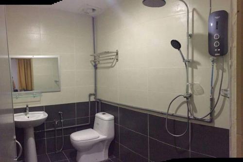 a bathroom with a shower and a toilet and a sink at JSK lovely home in Kuala Terengganu