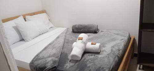 a bed with a stuffed animal on top of it at Hotel Estaciones in Guatapé