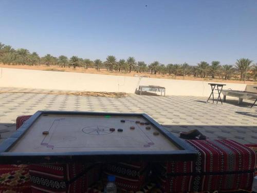 a ping pong table in front of a beach at Spacious Farm Stay with 3 bedroom & relaxing view in Remah