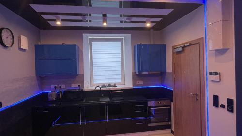 a kitchen with a sink and blue lights in it at TGHA Luxury Apartments in Athlone in Athlone