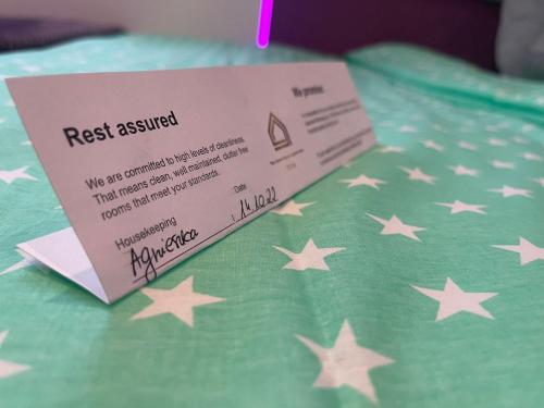 a request required sign sitting on top of a blanket with stars at TGHA Luxury Apartments in Athlone in Athlone