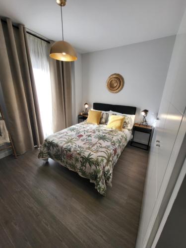 a bedroom with a bed and a large window at Alazán Jerez II-Parking gratis-wifi in Jerez de la Frontera