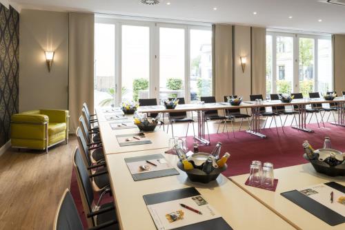 a conference room with long tables and chairs at Boutique-Hotel Amalienhof in Weimar