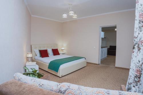 a bedroom with a bed and a couch at Hotel&Restaurant Premium Club in Yaremche