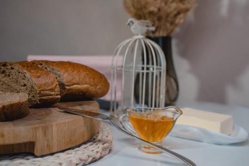 a spoon of bread and a glass of honey at Hotel&Restaurant Premium Club in Yaremche