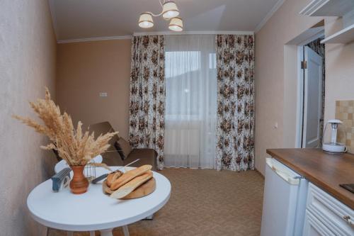 a kitchen with a table with a vase on it at Hotel&Restaurant Premium Club in Yaremche