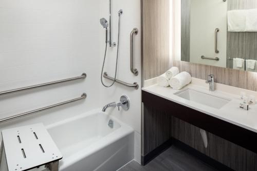 a bathroom with a tub and a sink and a shower at Holiday Inn Express Washington DC Downtown by IHG in Washington
