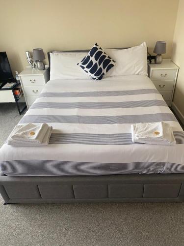 a large bed with two towels on top of it at My room in Edinburgh