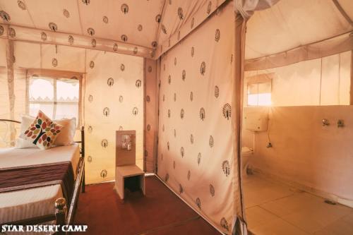 a bedroom with a rock climbing wall at Star Desert Camp Jaisalmer in Jaisalmer