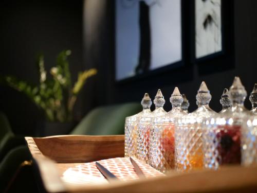 a group of glass bottles sitting on a table at 133 Boutique Hotel in Karlsruhe