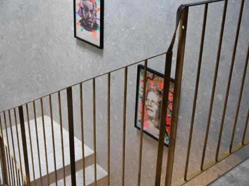 an overhead view of a staircase with two pictures at 133 Boutique Hotel in Karlsruhe