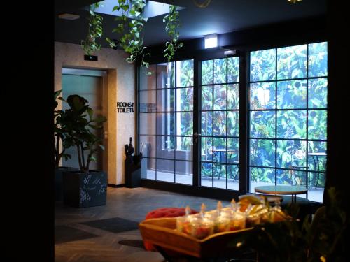 a room with large windows and a table with candles at 133 Boutique Hotel in Karlsruhe