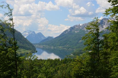 a view of a lake in the middle of mountains at Steirerhof in Bad Aussee