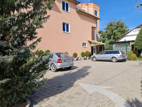 two cars parked in a parking lot in front of a building at Holiday in Ferizaj