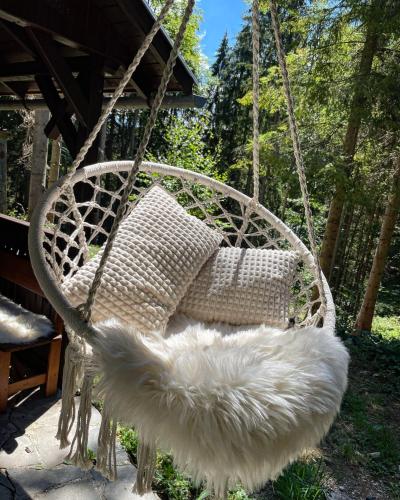 a white swinging chair with feathers on it at Chalet Látky in Látky