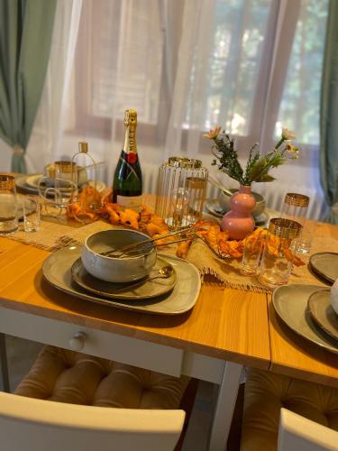 a table with plates and glasses and a bottle of wine at Chalet Látky in Látky