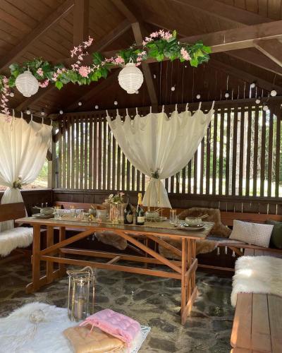 a dining room with a table and flowers on the ceiling at Chalet Látky in Látky