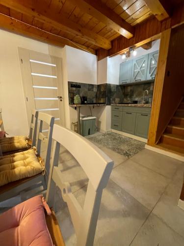 a living room with a couch and a kitchen at Chalet Látky in Látky