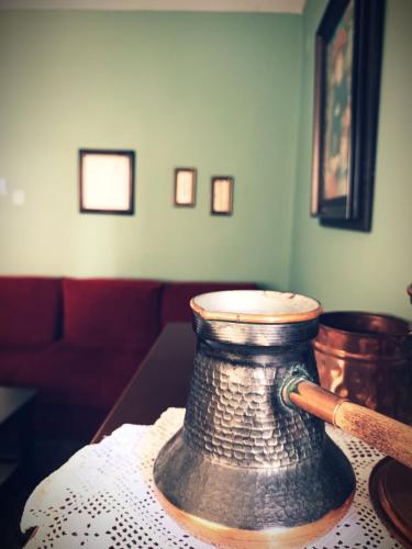 a vase sitting on a table with a baseball bat at Village House Grevena in Grevena