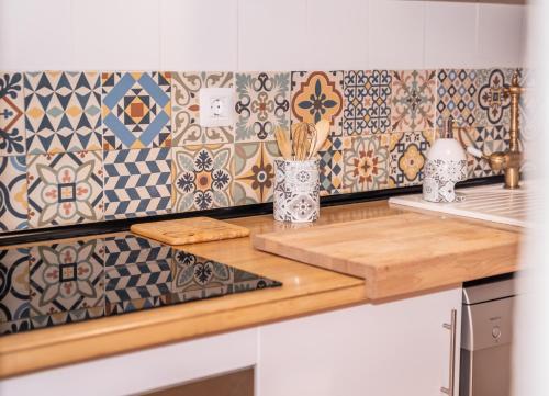 a kitchen with a counter top with tiles on the wall at Casa Buganvilla in Hermigua