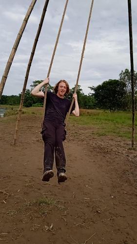 a woman swinging on a swing at Crocodile Safari Camp in Chitwan