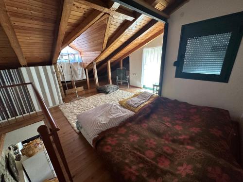 a bedroom with a bed in a room with wooden ceilings at Grandma's Place in Aïdonochórion