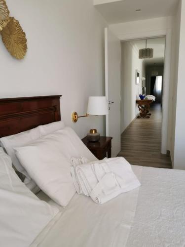 a white bed with two white pillows on top of it at B&B Le Torri in Santeramo in Colle