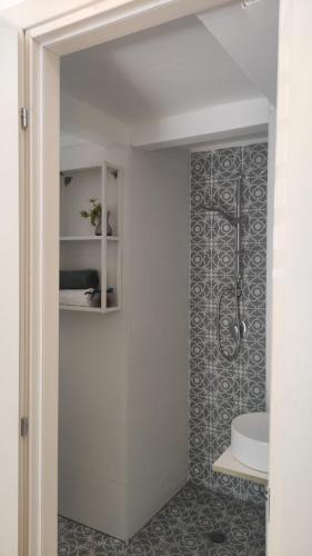 a bathroom with a shower and a toilet in it at Lovely studio with balcony in Rechovot