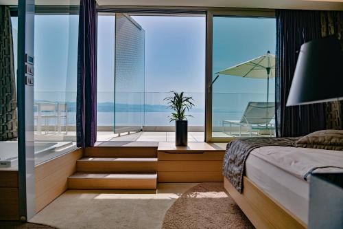 a bedroom with a bed and a view of the ocean at Bevanda Hotel & Restaurant - Unique Adriatic in Opatija