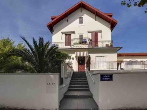 a white house with stairs leading up to it at APPARTEMENT 4 PERSONNES ARCACHON in Arcachon