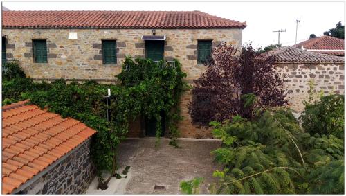 a large brick building with a courtyard in front of it at Terra Lemnia B in Repanídhion